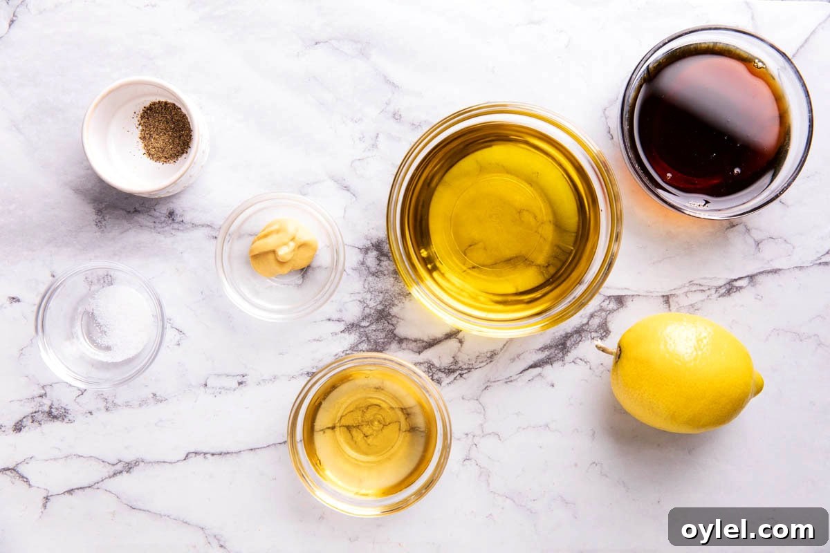 Maple Vinaigrette Recipe for Salads 3 Maple Vinaigrette ingredients in prep bowls including maple syrup, olive oil, apple cider vinegar, Dijon mustard, salt and pepper.