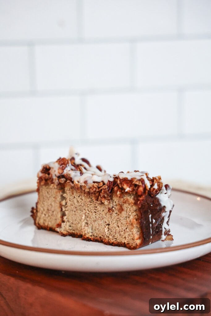 A slice of protein banana bread with streusel topping and glaze.
