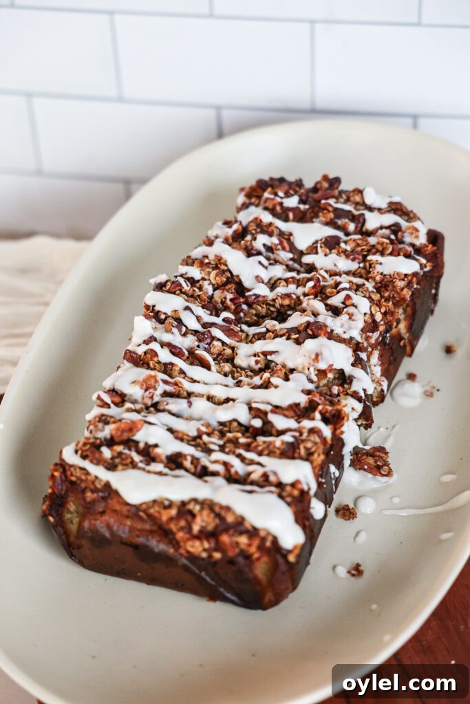 A slice of protein banana bread with streusel topping and glaze.