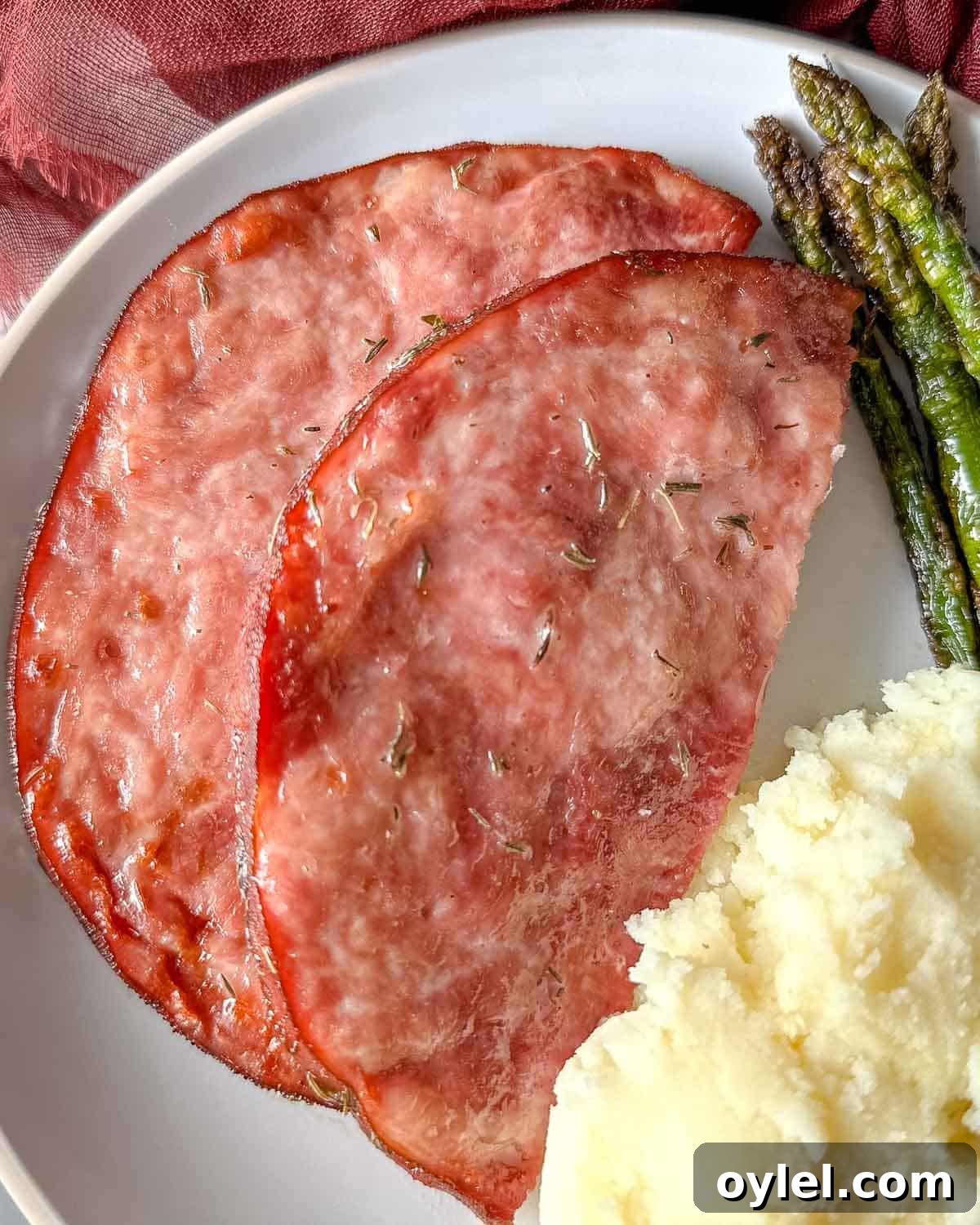air fryer ham steak with mashed potatoes and asparagus.