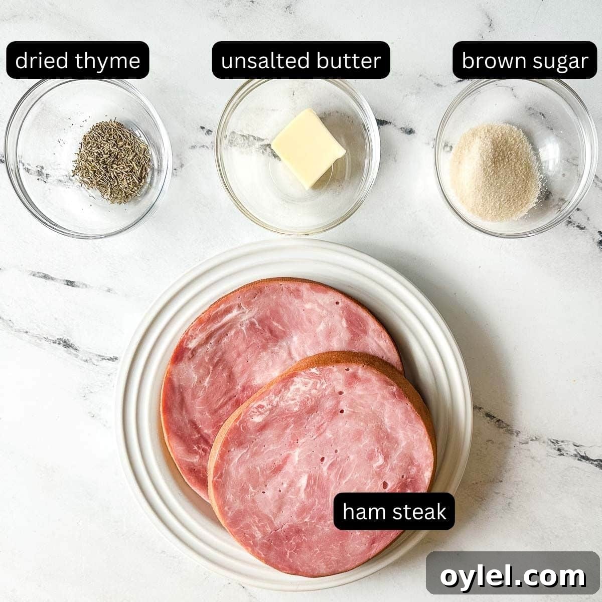 labeled ingredients for air fryer ham steak on a white marble counter.