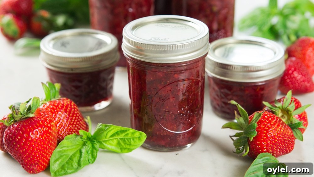 A jar with strawberry basil preserves sits on a table.