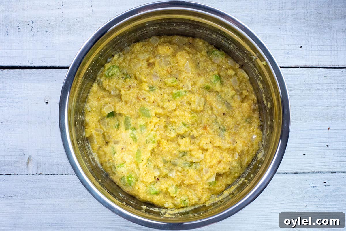 Classic Southern Cornbread Dressing Recipe 5 cornbread dressing batter in silver mixing bowl