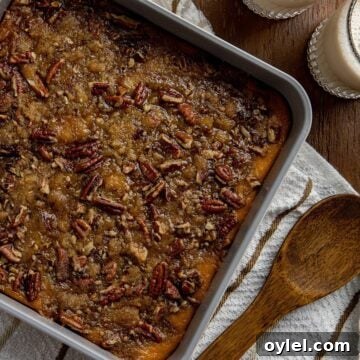 baked casserole in square dish with wooden spoon on the side.