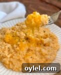 Quick and easy vegetable side dish for dinner made with frozen cauliflower rice, cream cheese, butter, cheddar, milk, and seasoning.