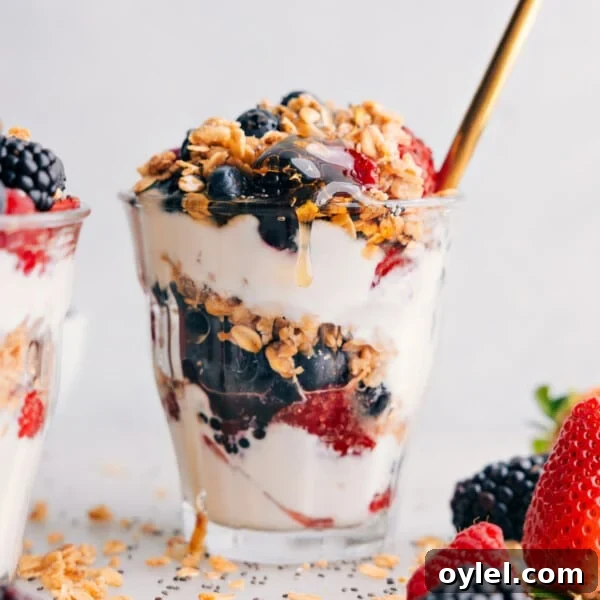 Layered yogurt parfait in a cup, showcasing layers of creamy yogurt, fresh fruit, and crunchy granola.