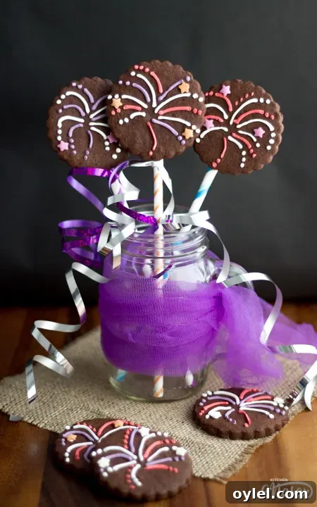 3 firework biscuits in a jar with colourful curling ribbon.