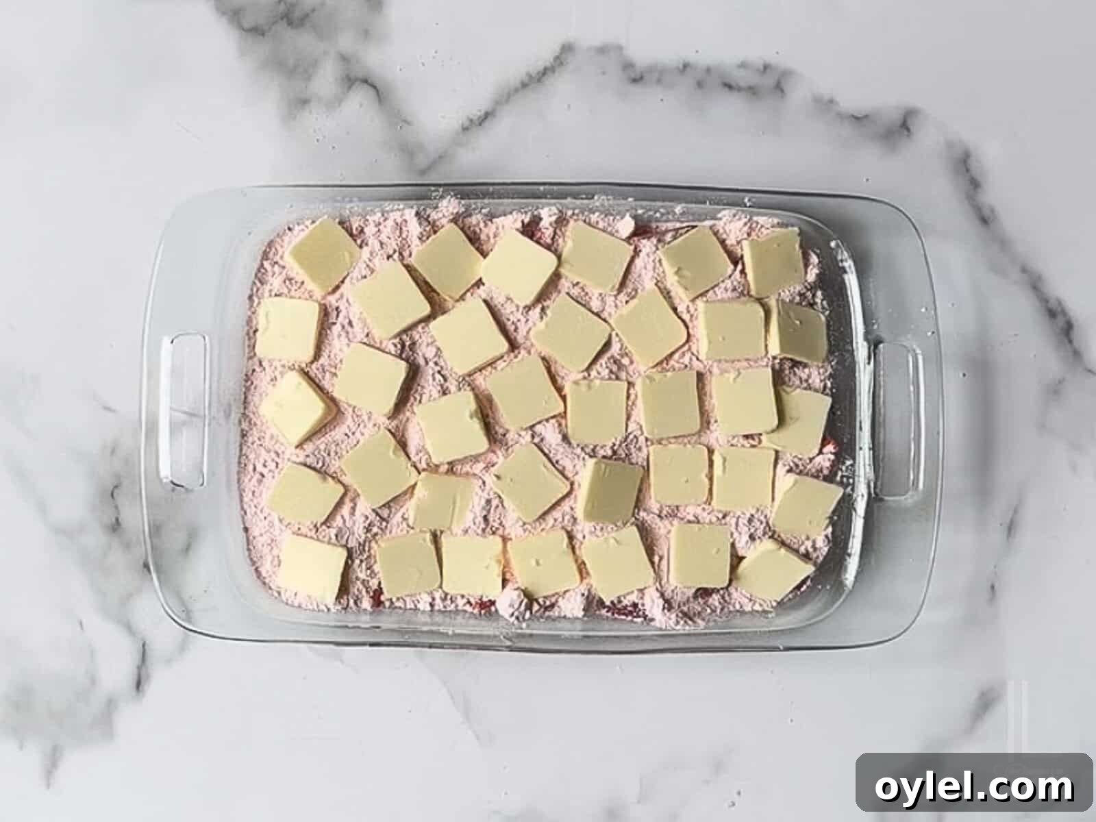 One-Bowl Strawberry Dump Cake Recipe 9 thin pats of cold butter scattered over the dry cake mix.