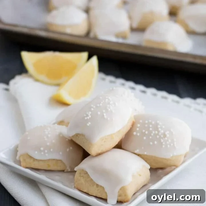 Iced Lemon Pillow Cookies. A soft, petite, pillow shaped cookie, flavored with fresh lemon zest and then coated in fresh lemon icing. A perfect tea cookie!
