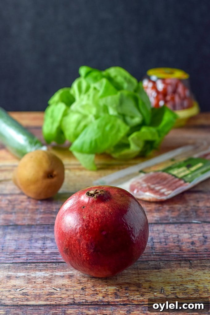 The ingredients for the salad including the Pomegranate, pear, bacon, cucumber, tomato and Boston lettuce