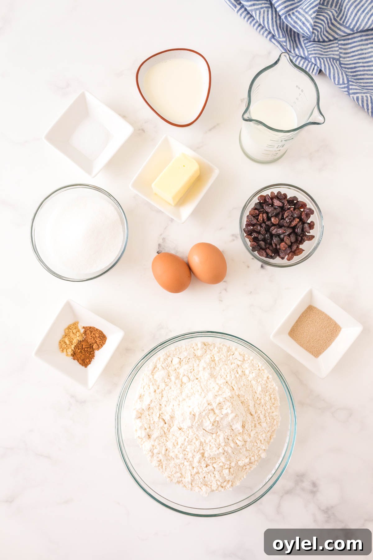 Homemade Hot Cross Buns Recipe for Easter 4 Ingredients for the Hot Cross Bun Recipe: Raisins, Hot Water, Warm Milk, Active Dry Yeast, Sugar, Flour, Spices, Eggs, Cream, Butter