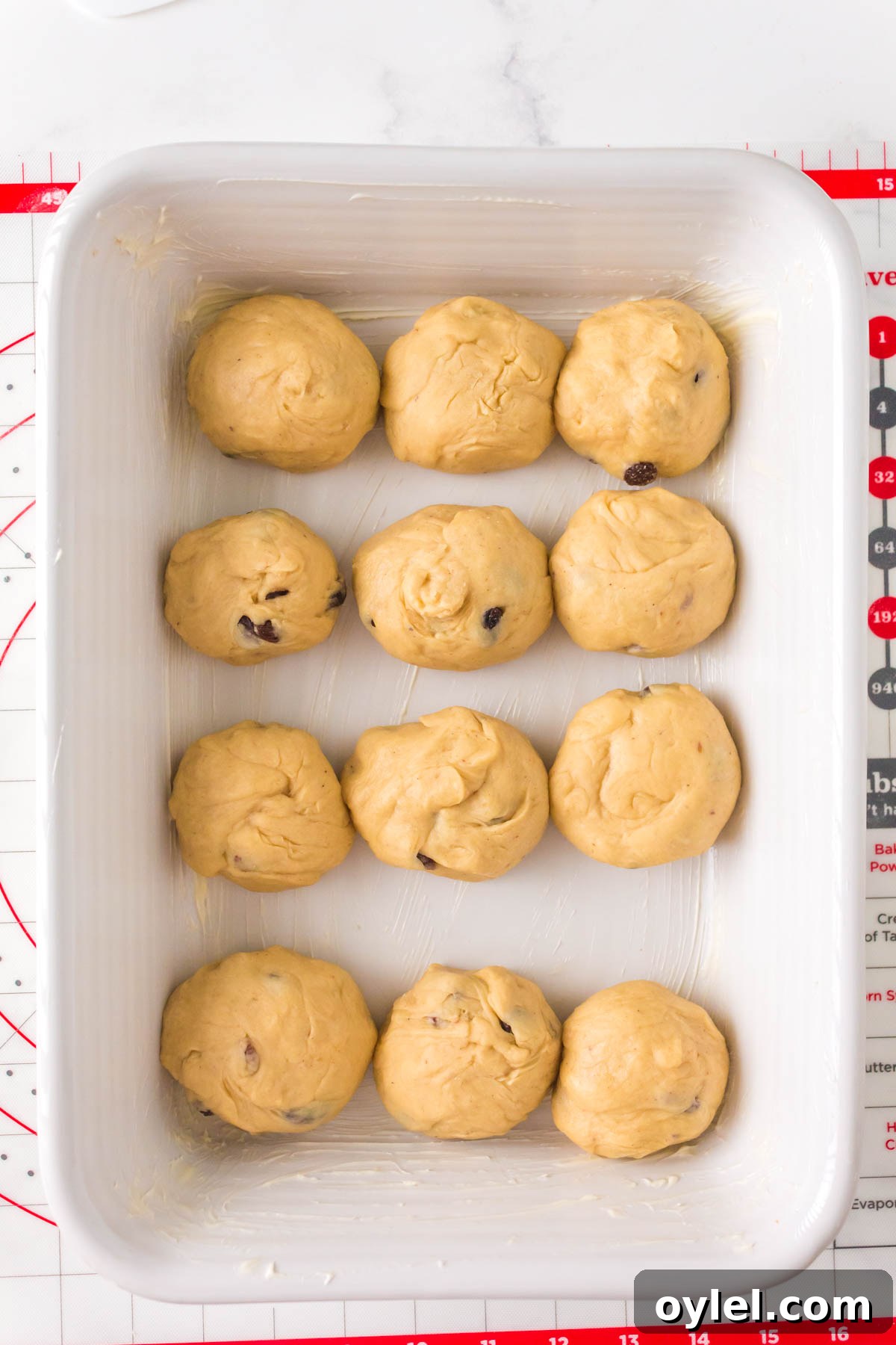 Homemade Hot Cross Buns Recipe for Easter 5 rolls in a pan.