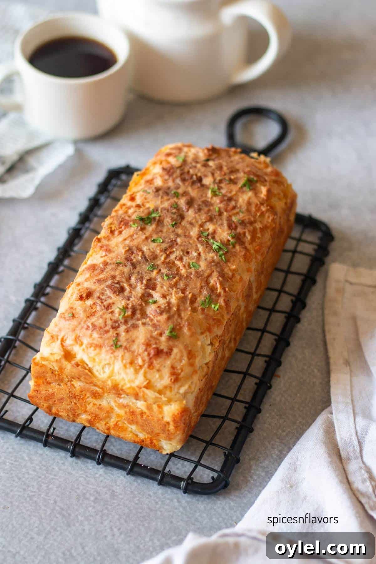baked cheddar cheese bread placed on a wire rack