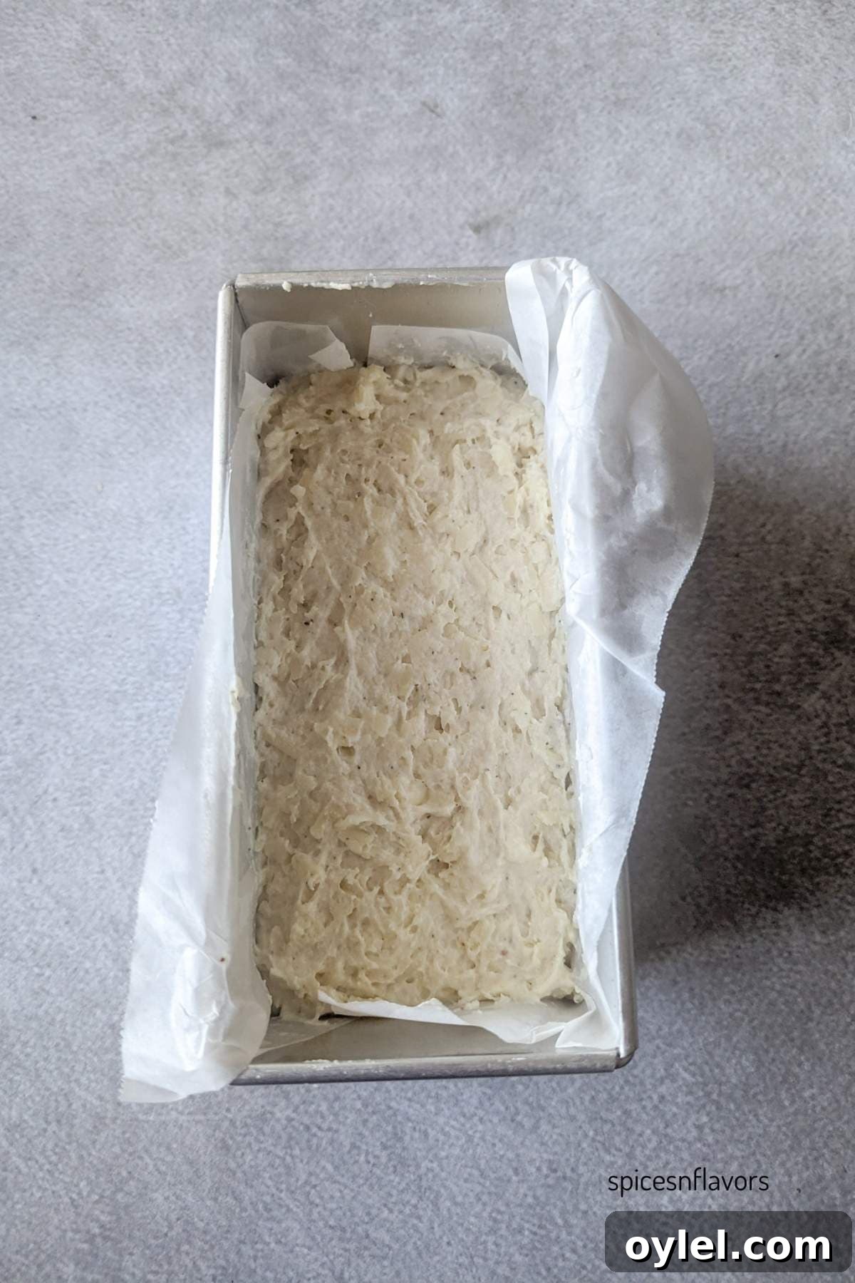 transferring cheddar cheese bread batter to a pan
