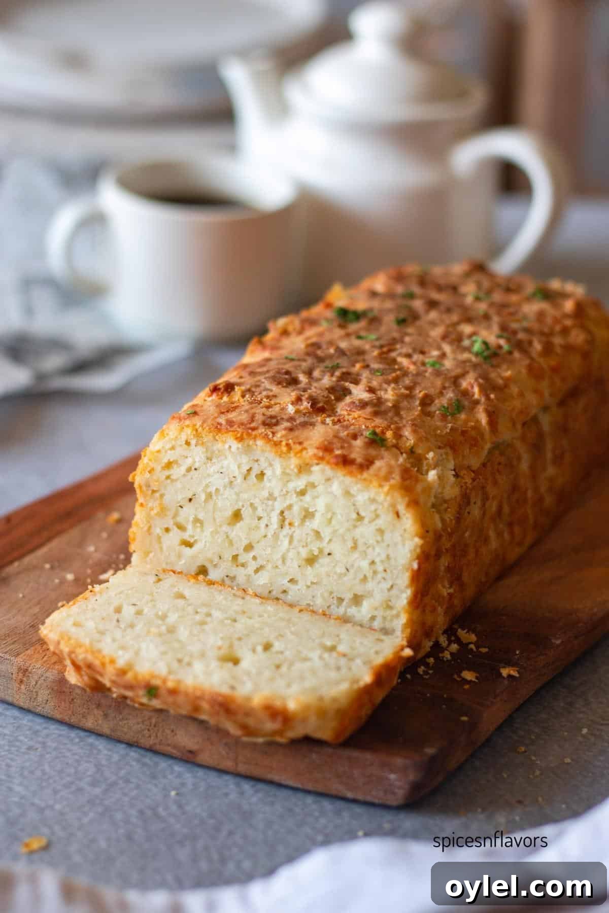 sliced cheddar cheese bread placed on a wooden board
