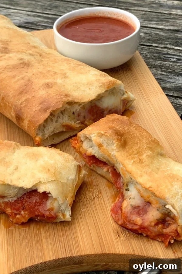 Slices of pepperoni and cheese stromboli from frozen bread dough on cutting board.