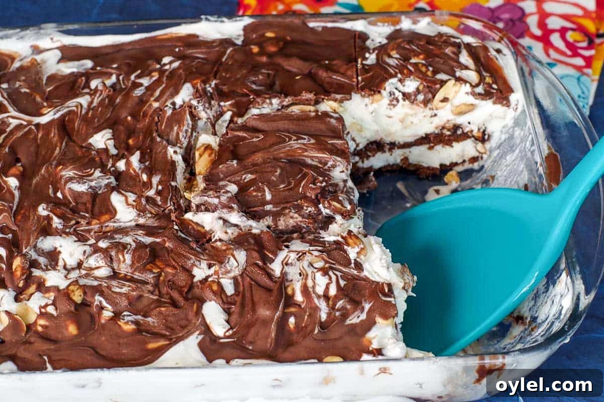 buster bar cake with piece missing, with turquoise spatula in pan