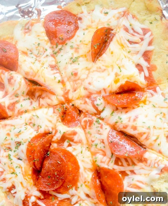 Fat head dough topped with pizza sauce, cheese and tomatoes.