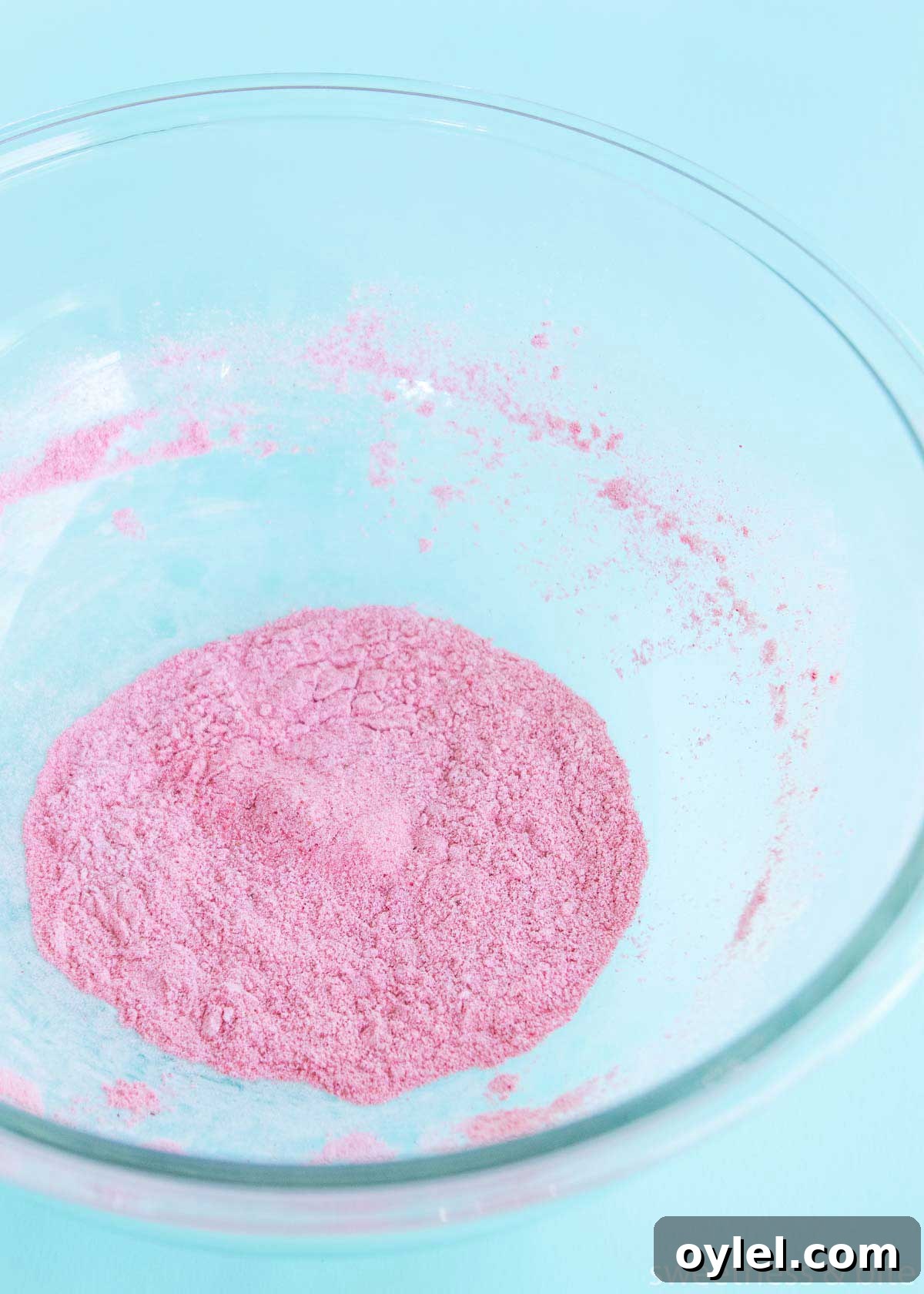 Freeze dried raspberry powder and icing sugar mixed together in a large bowl.