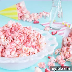 White bowl of pink fruit-flavoured popcorn.