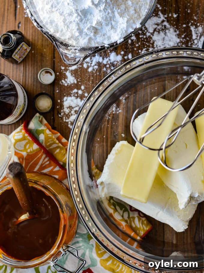 A clear mixing bowl with butter and cream cheese in it.
