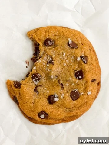 a single serve pumpkin cookie with a bite missing.