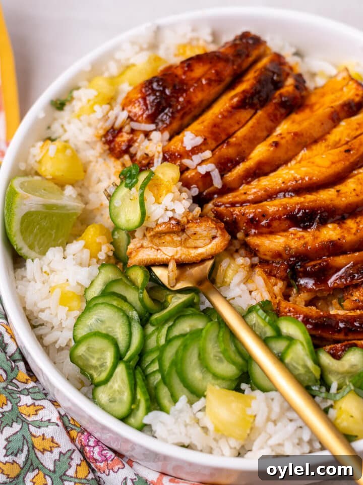 Crispy Roasted Honey-Lime Chicken Thighs 16 Rice, chicken, pineapple and cucumber on a gold fork