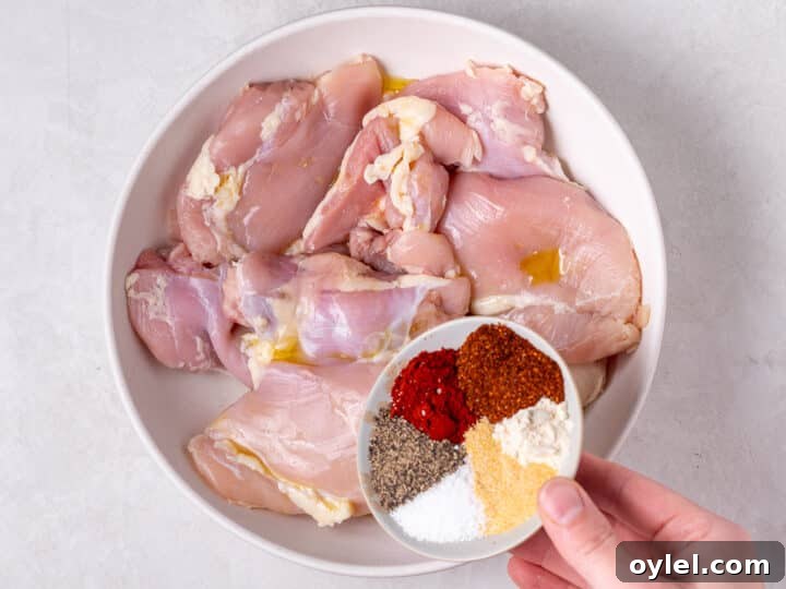 Crispy Roasted Honey-Lime Chicken Thighs 5 Raw boneless skinless chicken thighs in a bowl with olive oil before seasoning