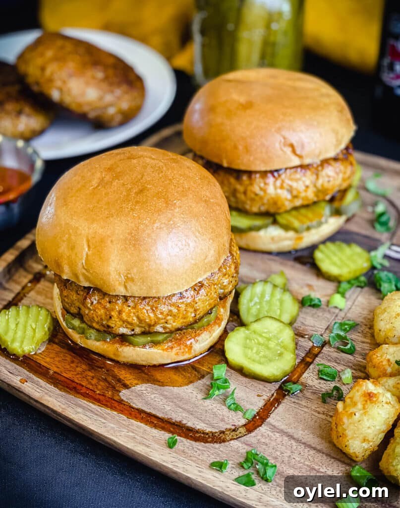 Nashville Hot Seasoning Recipe: Homemade Spice Blend 3 Nashville hot chicken burgers on a wood plate