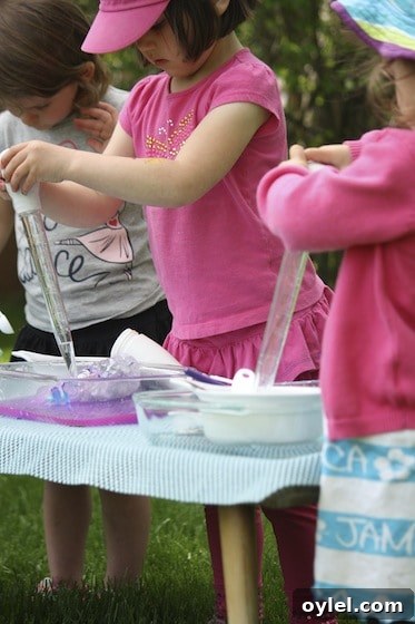 Melt Elsa's Frozen Hands: Preschool Sensory Science Experiment 9 preschoolers using basters to melt ice