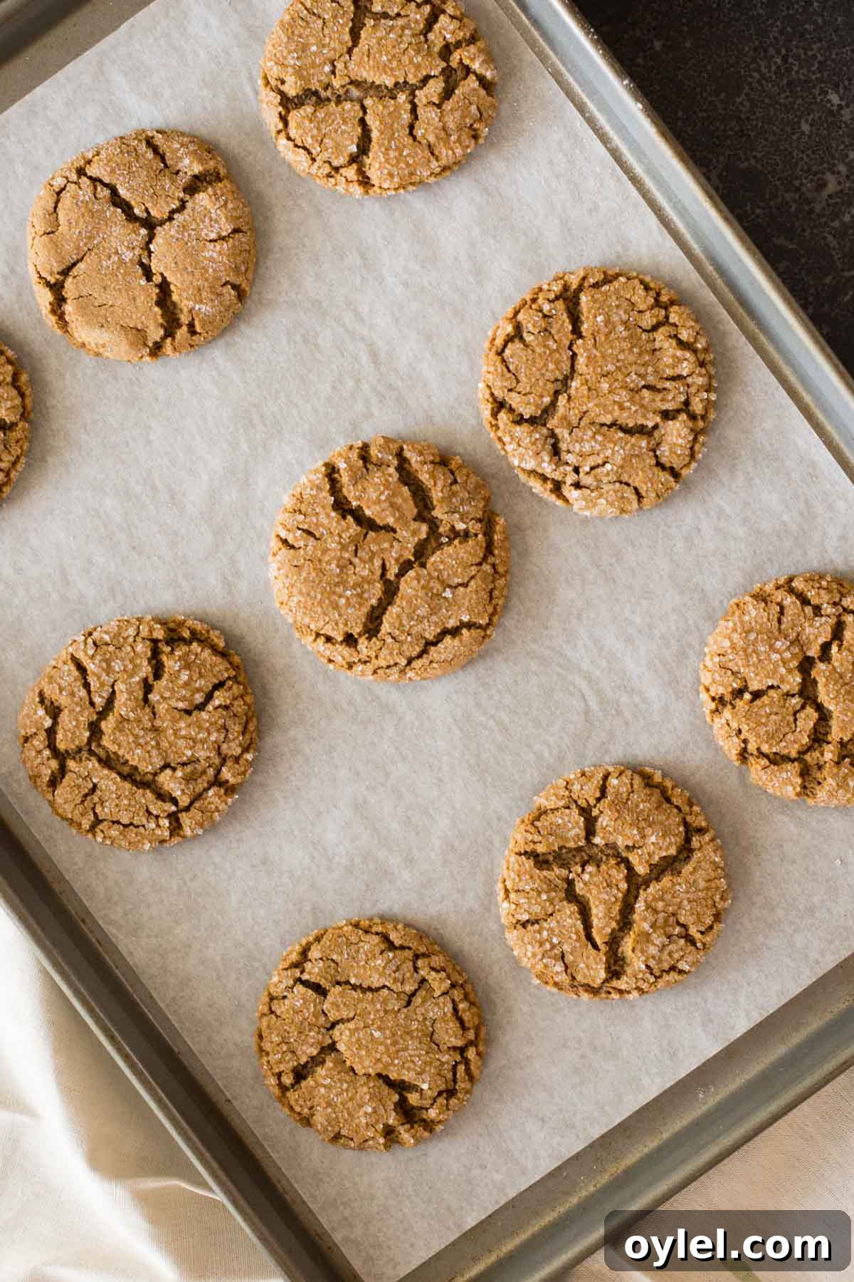 Peanut Butter Molasses Cookies on a parchment paper lined baking sheet.