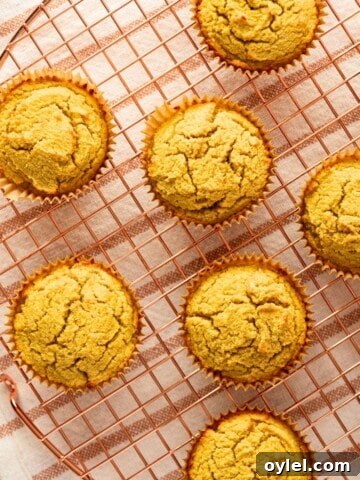 A wire rack with cornbread muffins on it.