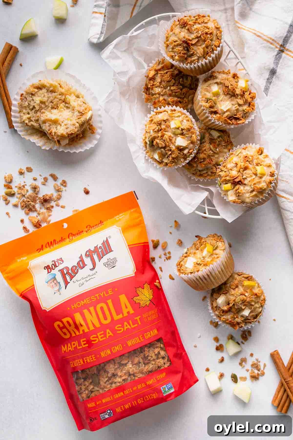 A bag of granola next to a basket of muffins.