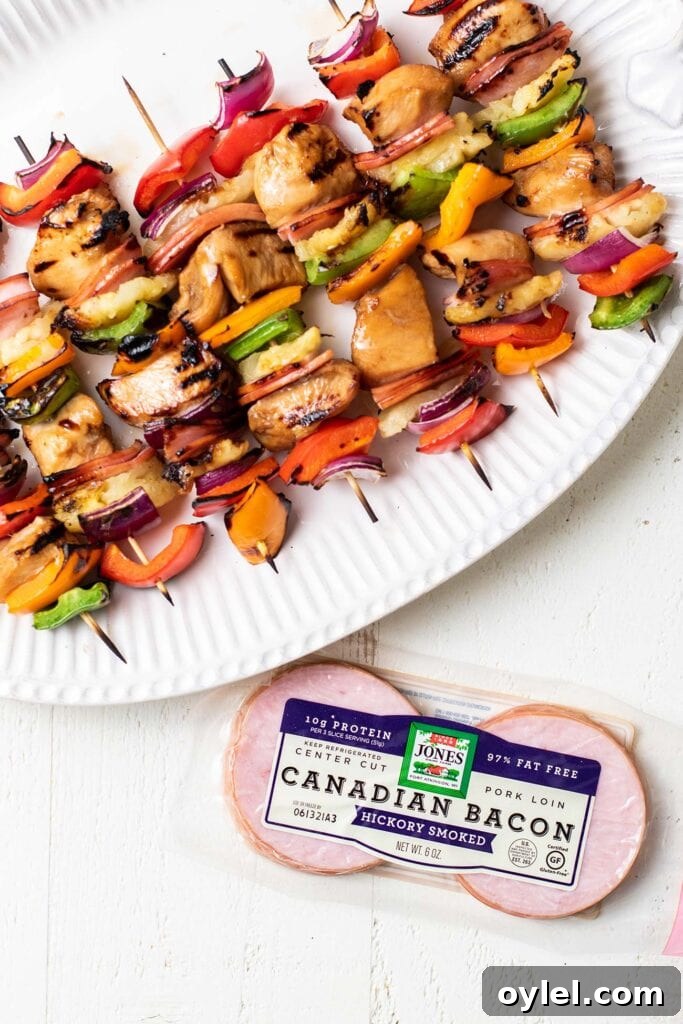 A platter of grilled teriyaki chicken skewers next to a package of Jones Dairy Farm Canadian Baon.