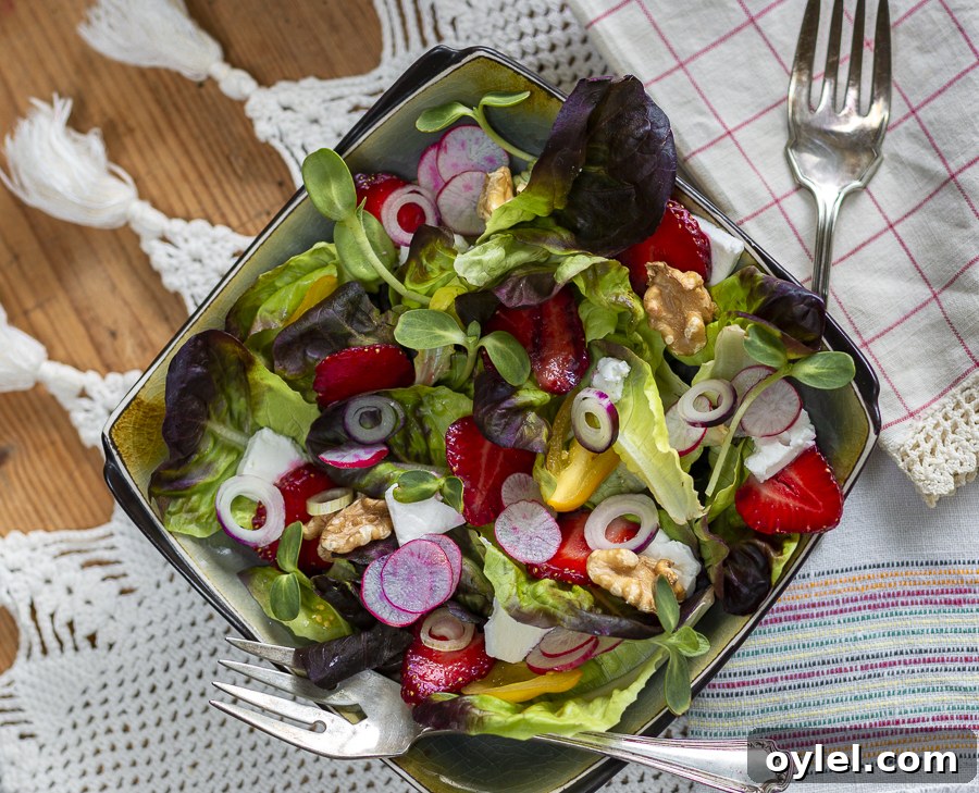 20 Spring Recipes to Brighten Your Table 10 Summer Strawberry Salad with Walnuts, Feta and Maple-Walnut Vinaigrette in a square bowl