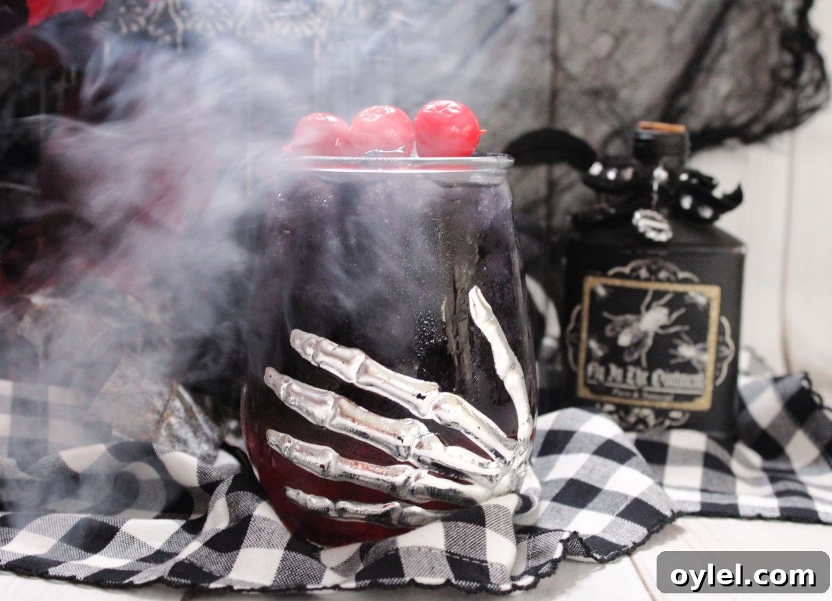 Fog over black widow cocktail in a glass.