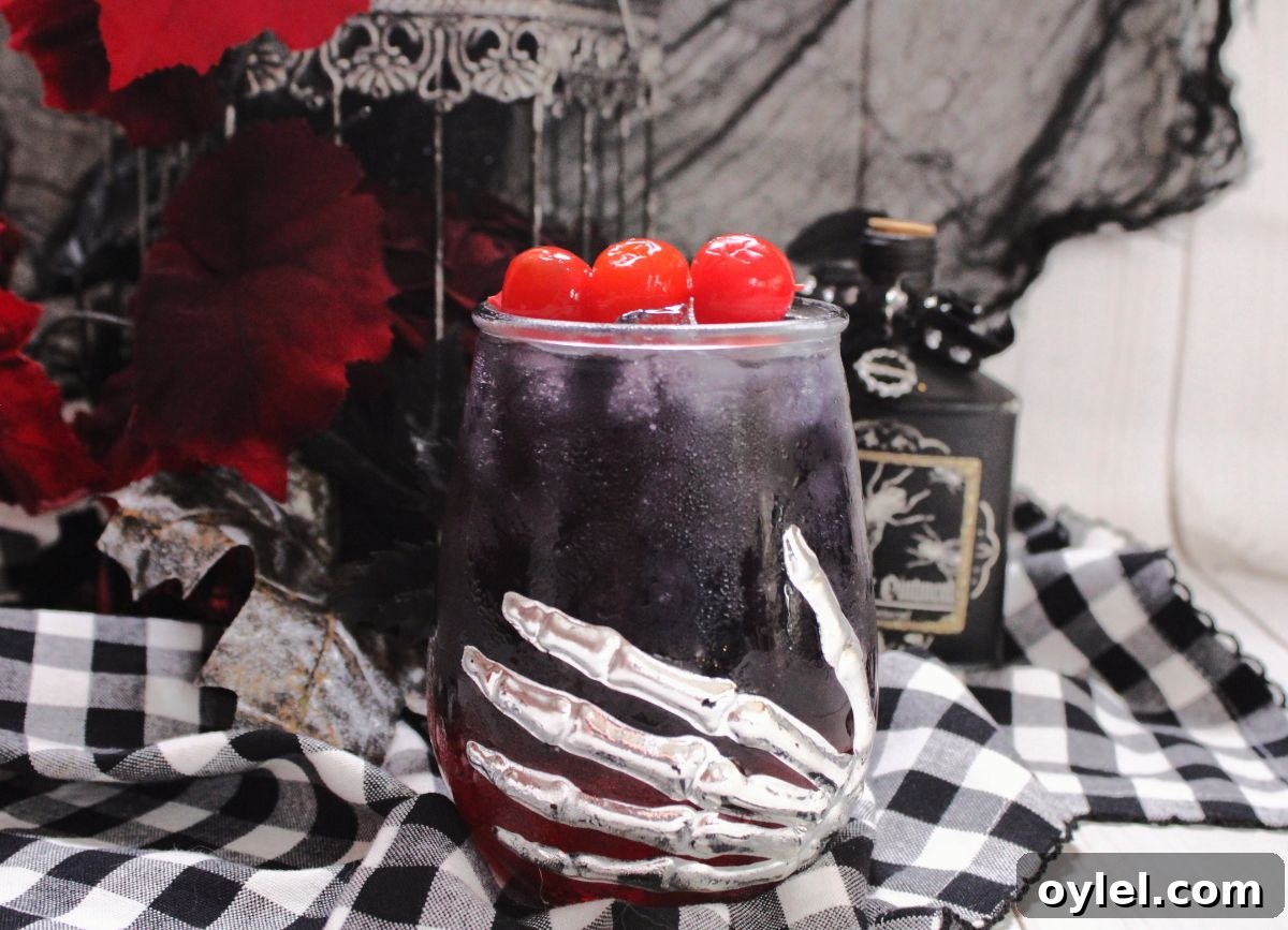 A glass with a skeleton hand and black widow drink.