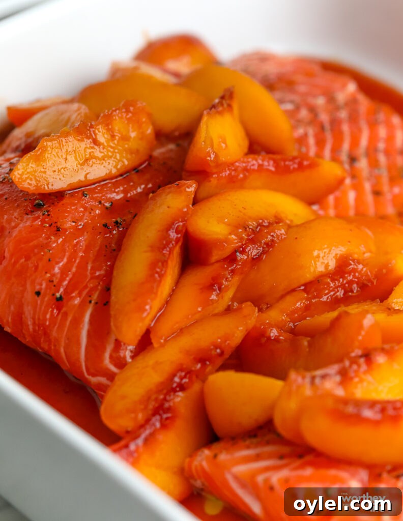 Brown Sugar Peach Glazed Salmon Recipe 8 Salmon filet covered with fresh peaches in baking pan