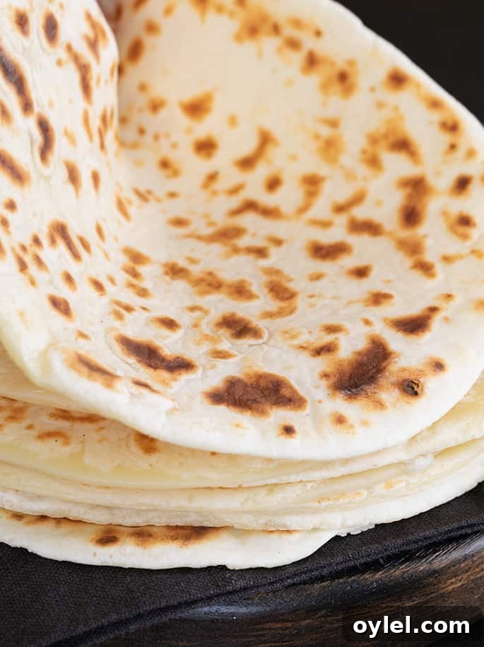 Soft Grain-Free Tapioca Wrap Recipe 2 A close up of a stack of soft tapioca wraps, one being bent.