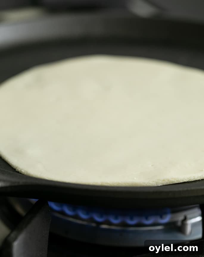 Soft Grain-Free Tapioca Wrap Recipe 3 Raw soft tapioca wrap being cooked in a pan