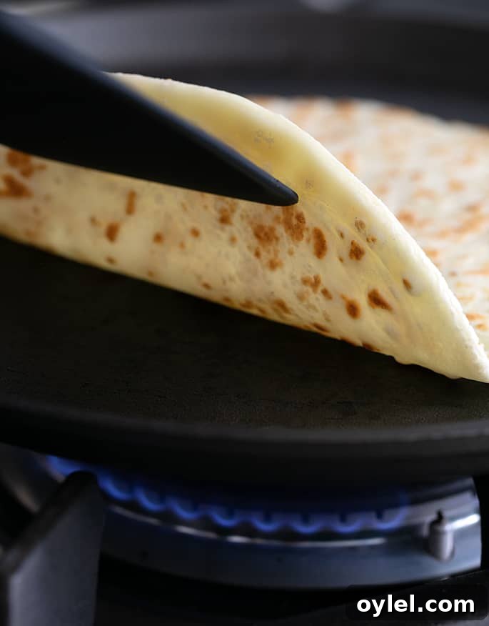 Soft Grain-Free Tapioca Wrap Recipe 4 Flipping over a soft tapioca wrap with a spatula