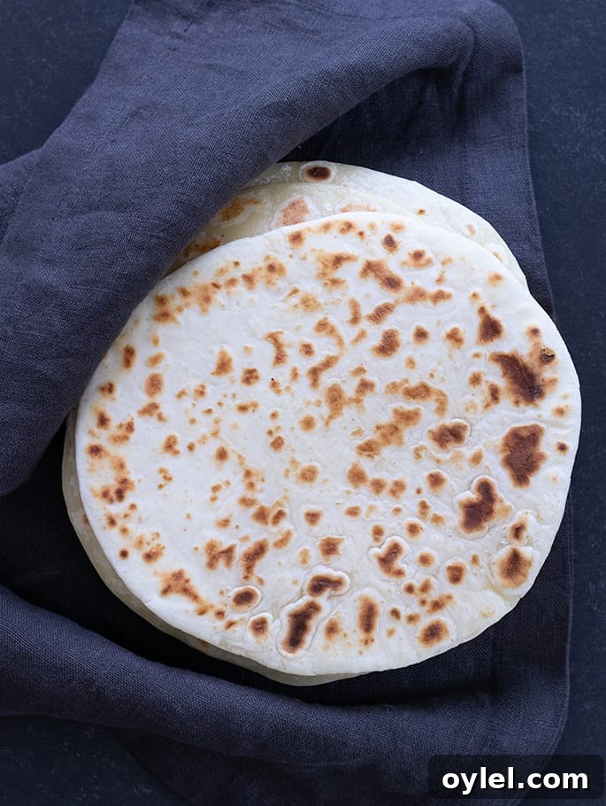 Soft Grain-Free Tapioca Wrap Recipe 5 Overhead image of soft tapioca wraps in a stack with a cloth