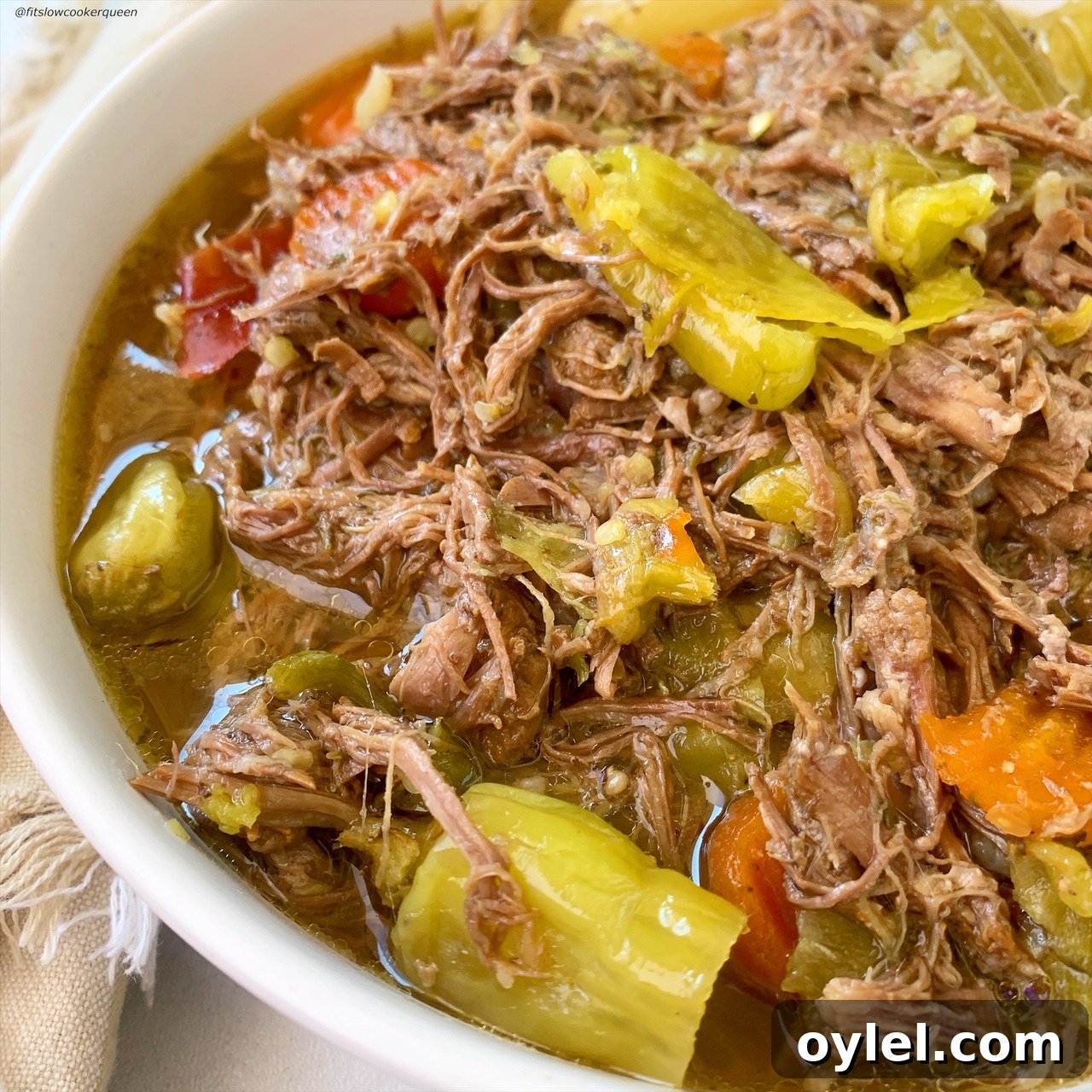 side shot of cooked italian beef in a bowl