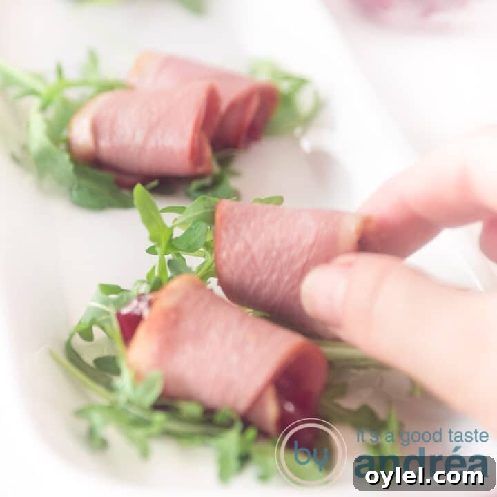 A square photo of three snacks with smoked duck filled with cranberry compote