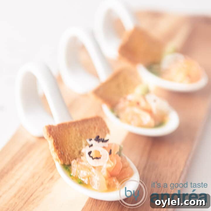 A wooden board with three white spoons filled with salmon, arugula oil and a piece of toast, angled