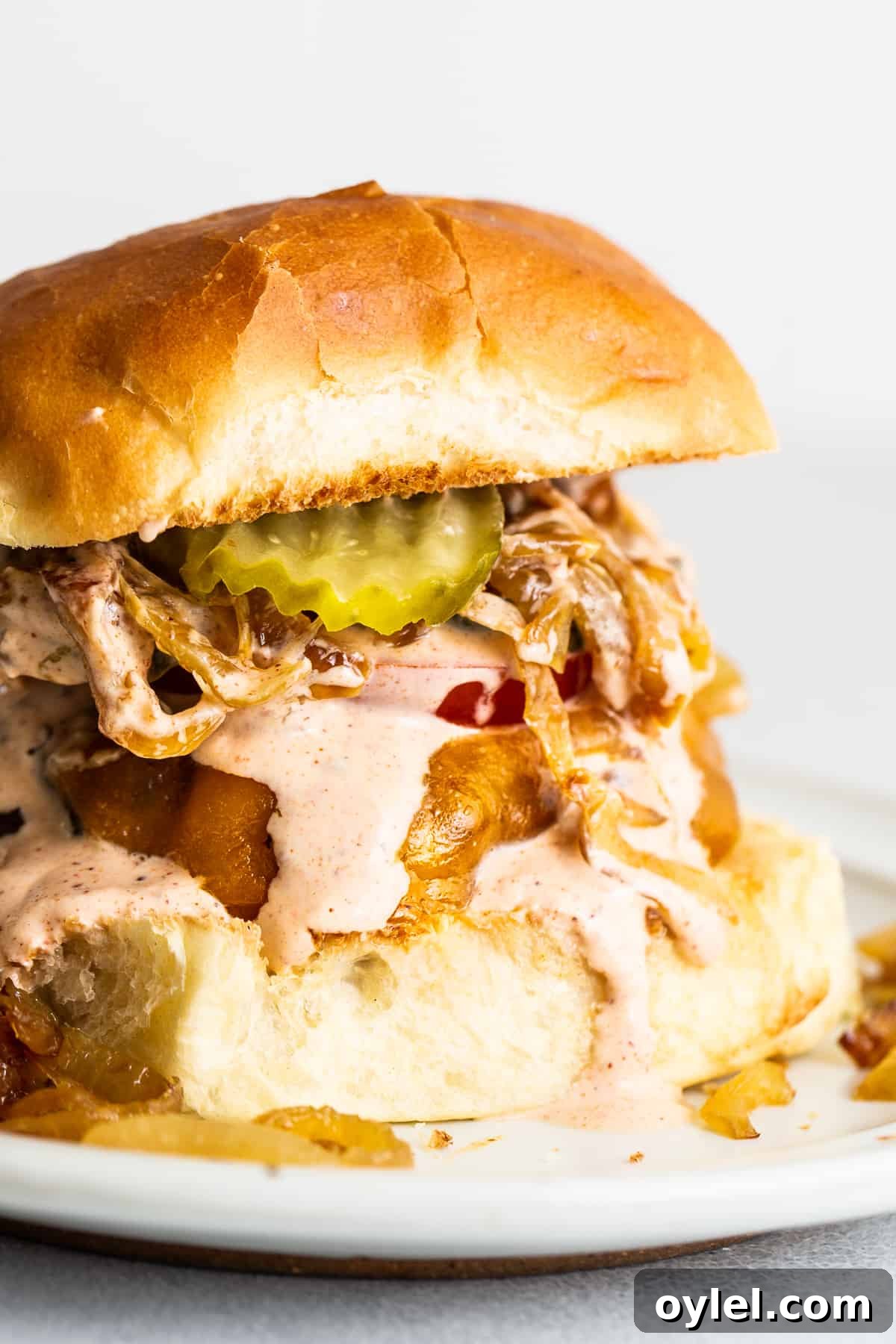 This easy burger sauce is our go-to recipe! No more store-bought burger sauce filled with ingredients you can’t pronounce. You'll never make burgers without this sauce again! Burger topped with burger sauce and other toppings.