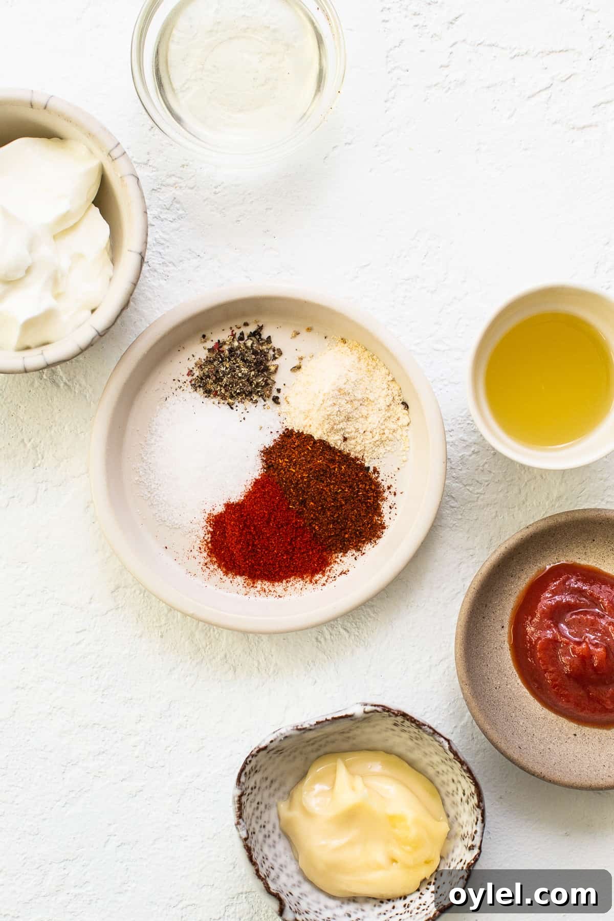 This easy burger sauce is our go-to recipe! No more store-bought burger sauce filled with ingredients you can’t pronounce. You'll never make burgers without this sauce again! Ingredients for easy burger sauce in bowls.