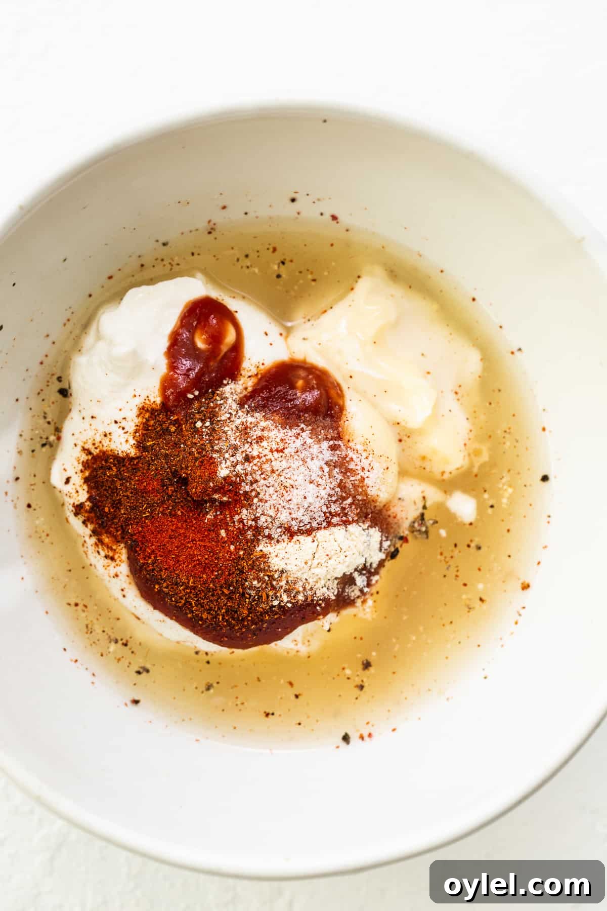 This easy burger sauce is our go-to recipe! No more store-bought burger sauce filled with ingredients you can’t pronounce. You'll never make burgers without this sauce again! Burger sauce ingredients in a bowl.