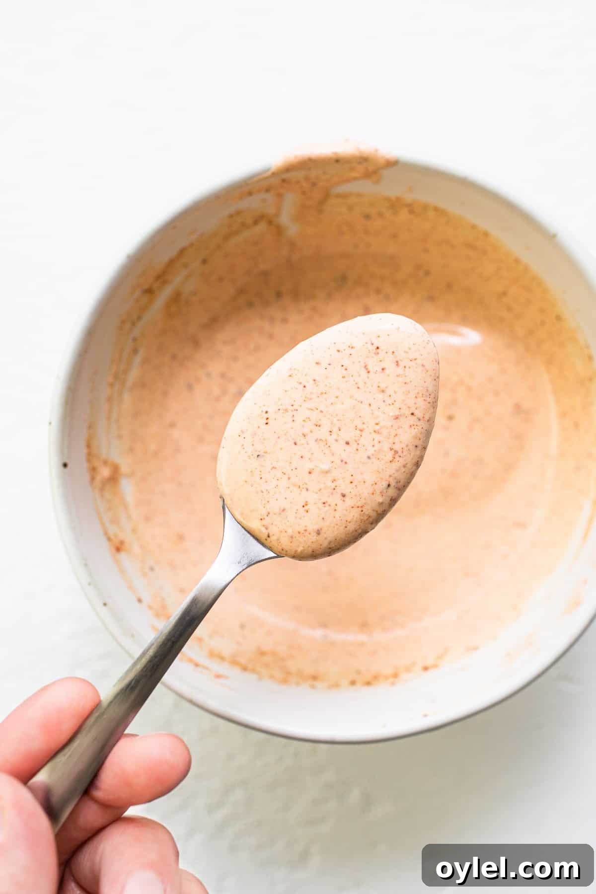 This easy burger sauce is our go-to recipe! No more store-bought burger sauce filled with ingredients you can’t pronounce. You'll never make burgers without this sauce again! Burger sauce on a spoon.