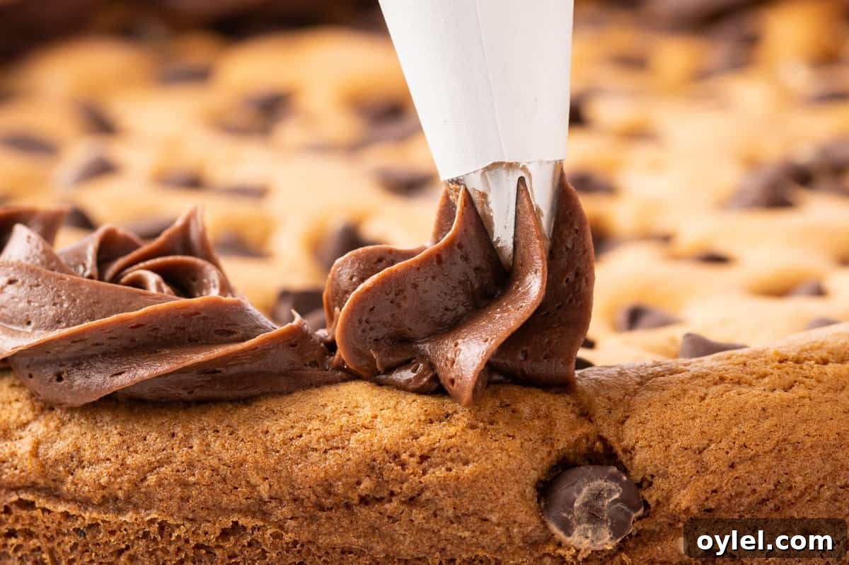 How to Make a Chocolate Chip Cookie Cake 24 piping chocolate frosting onto cookie cake